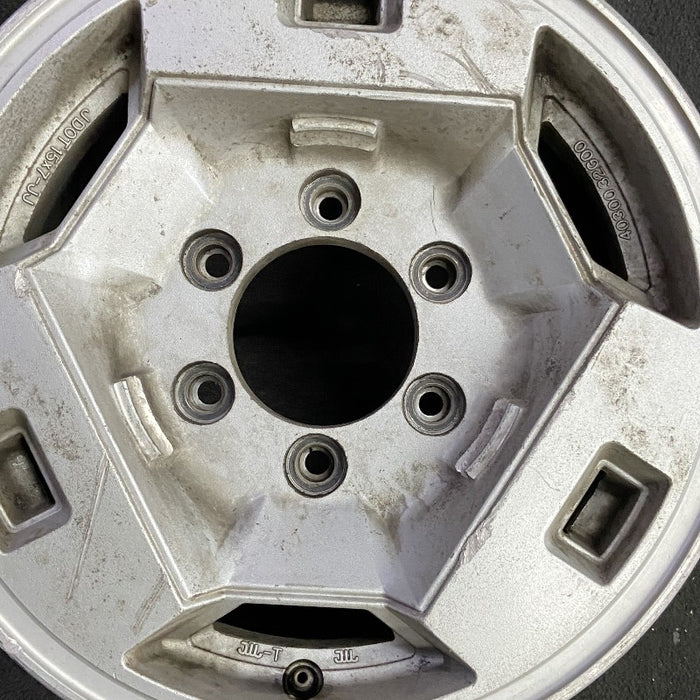 15" NISSAN PICKUP 86 D21 4x4 15x7 alloy frt Original OEM Wheel Rim - Angle View